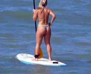 Enrapturing culo in panty bathing suit on surfboard.